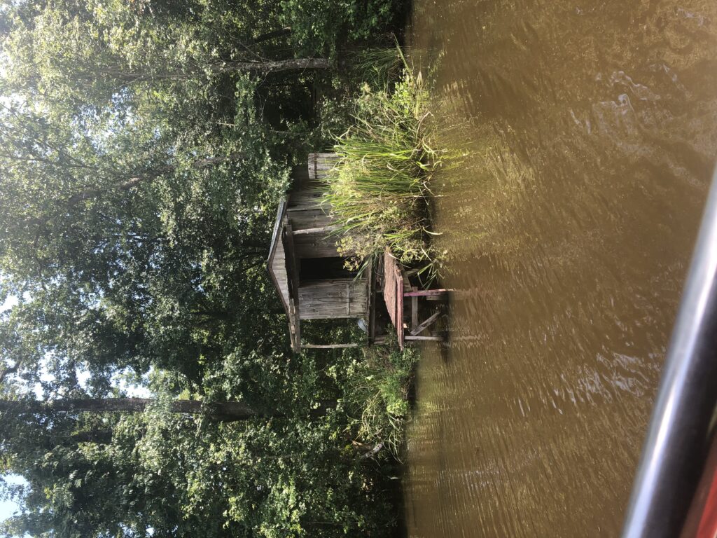 A small hut is in the middle of a river.