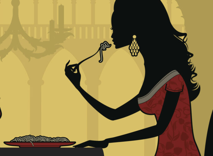 A woman in red dress eating food from pan.