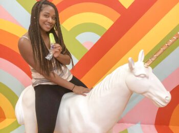 A woman sitting on top of a white unicorn.