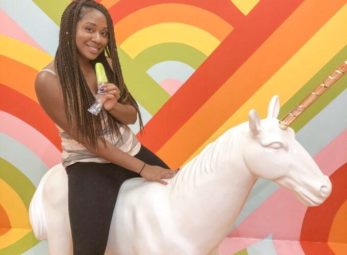 A woman sitting on top of a white unicorn.