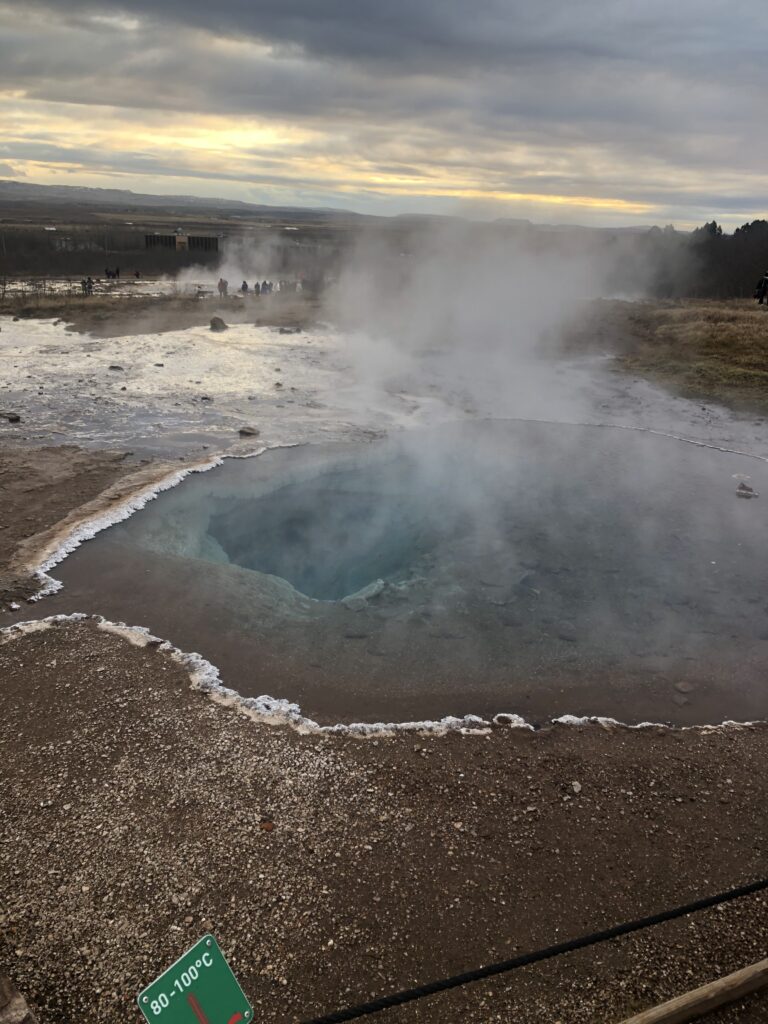 A hot spring with steam coming out of it.
