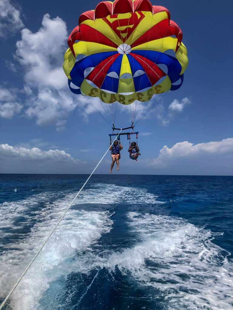 A person parasailing over the ocean on a sunny day.